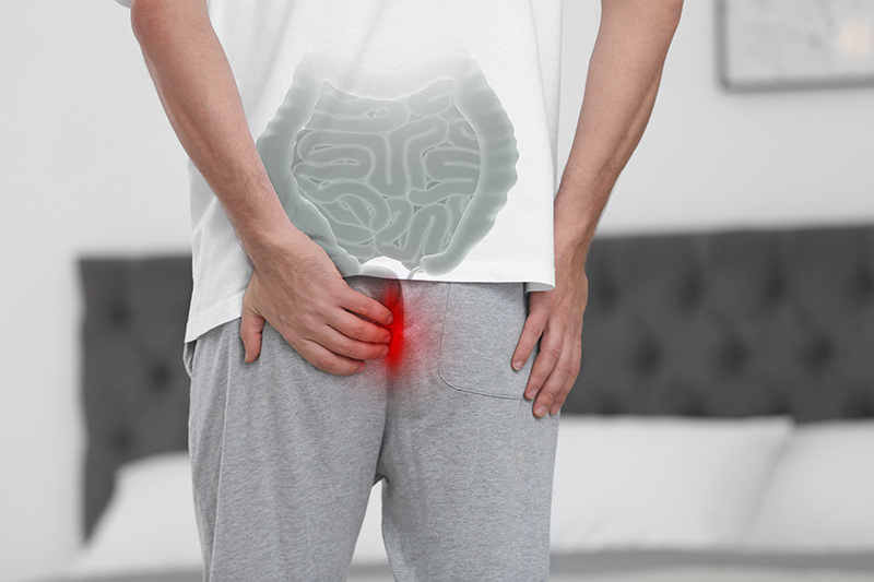 Man experiencing discomfort due to painful piles.